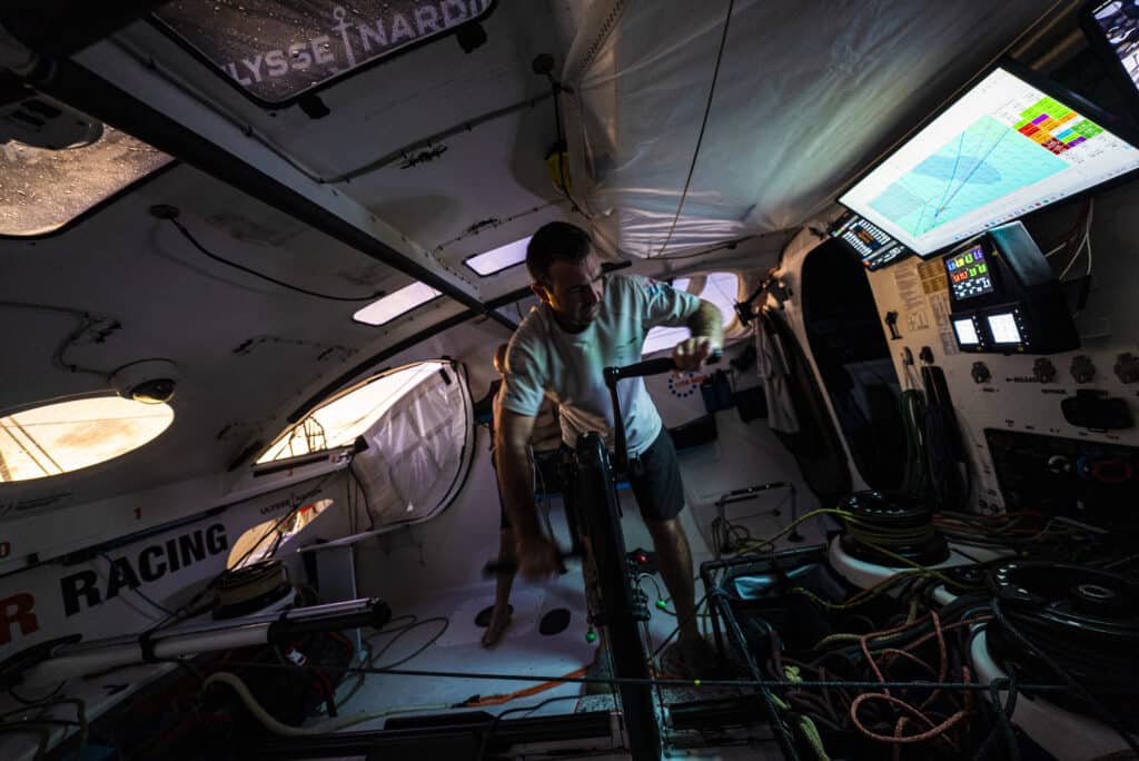 Charlie Enright grinding inside the cockpit of Mālama